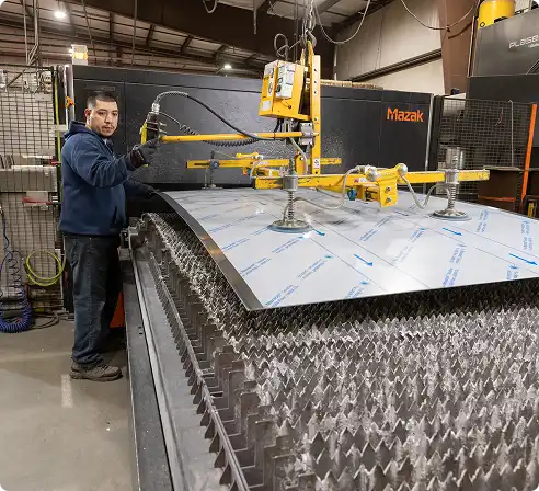 Person operating a Mazak machine in a factory setting