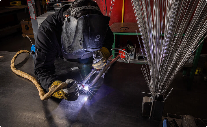 Welder fabricating aluminum tanks for agriculture industry