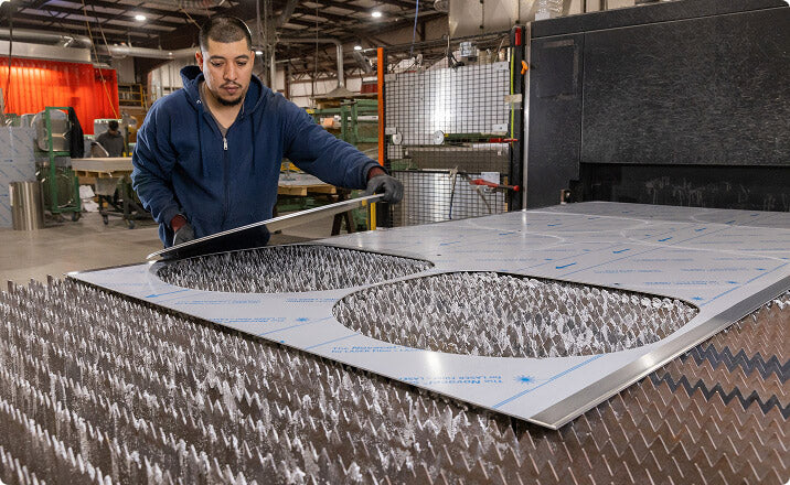 Worker fabricating aluminum panels for mobile medical vehicles