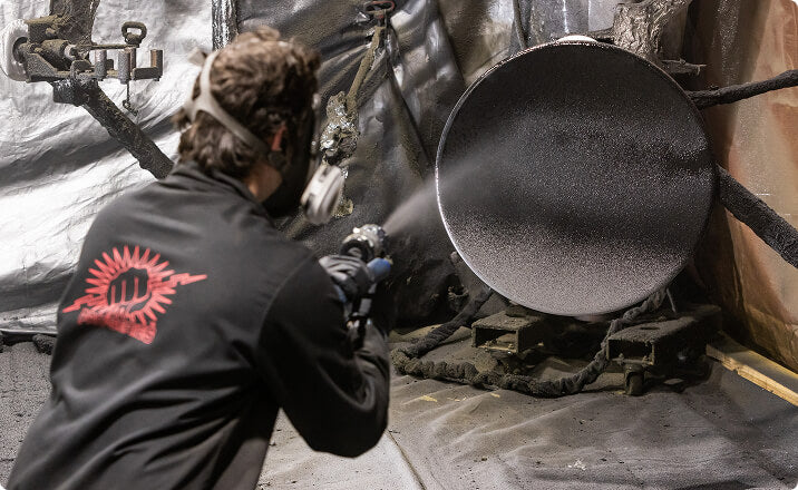 Technician coating aluminum tank for railroad industry