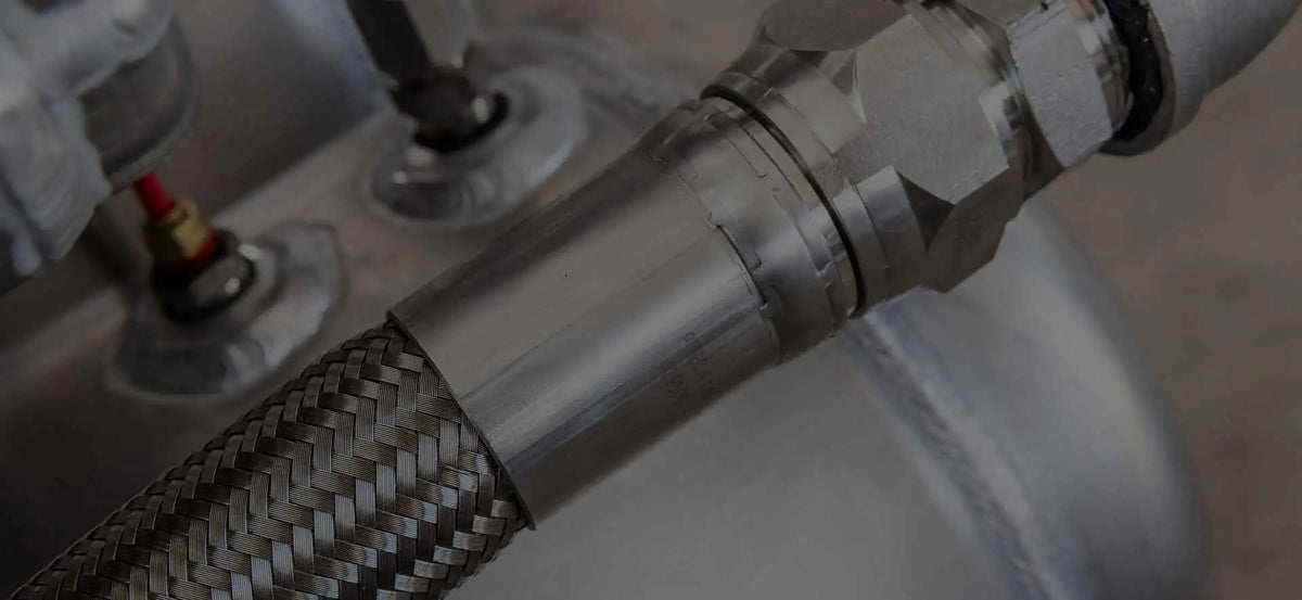 Close-up of a metal hose connection with a blurred background